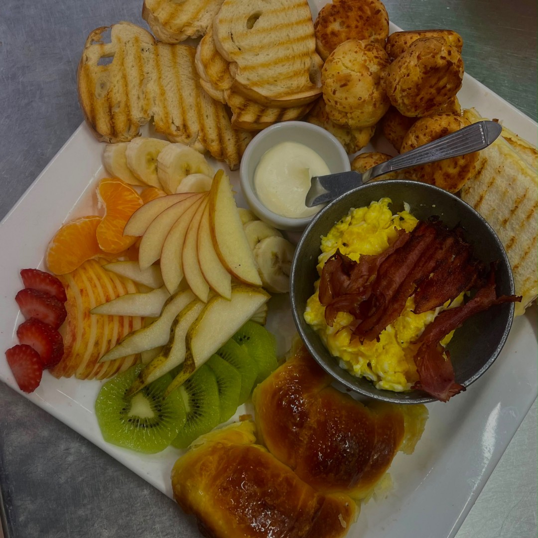 Brunch para dos con huevos revueltos con panceta, tostadas, queso crema, chipá, frutas de estación y medialunas